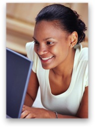 Woman happily using her laptop
