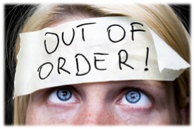 Woman with "out of order" taped across her forehead