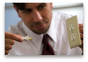 Man demonstrating how to put a plug into a socket