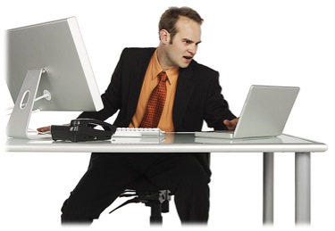 Businessman watching two computer monitors
